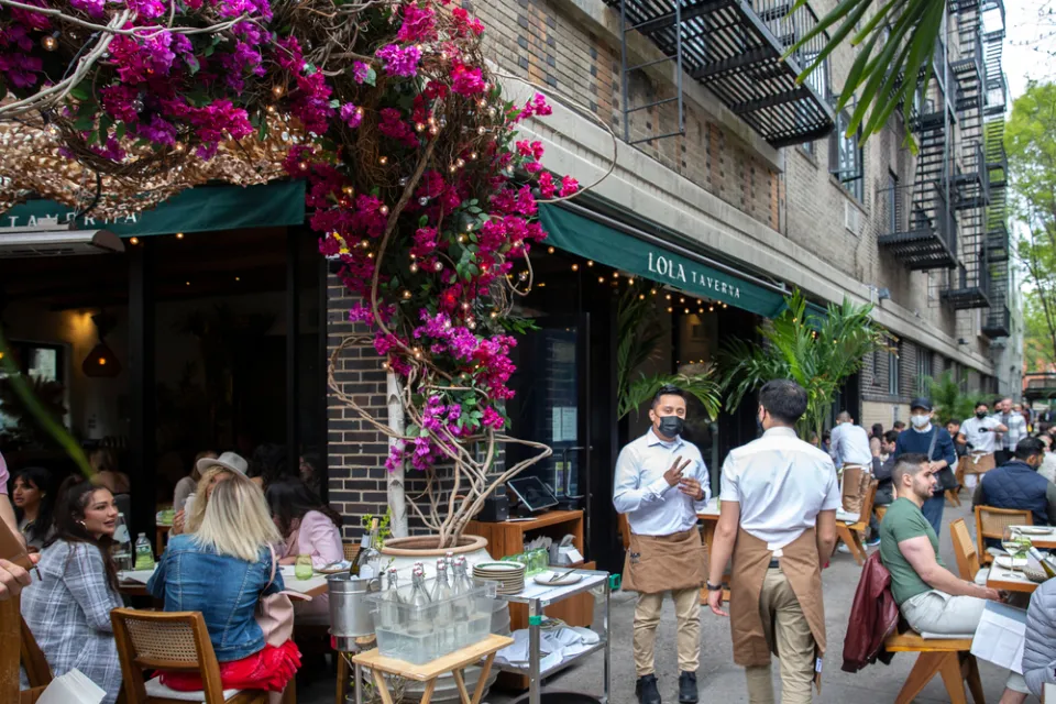 Busy restaurant seating on New York City sidewalk during COVID-19 pandemic
